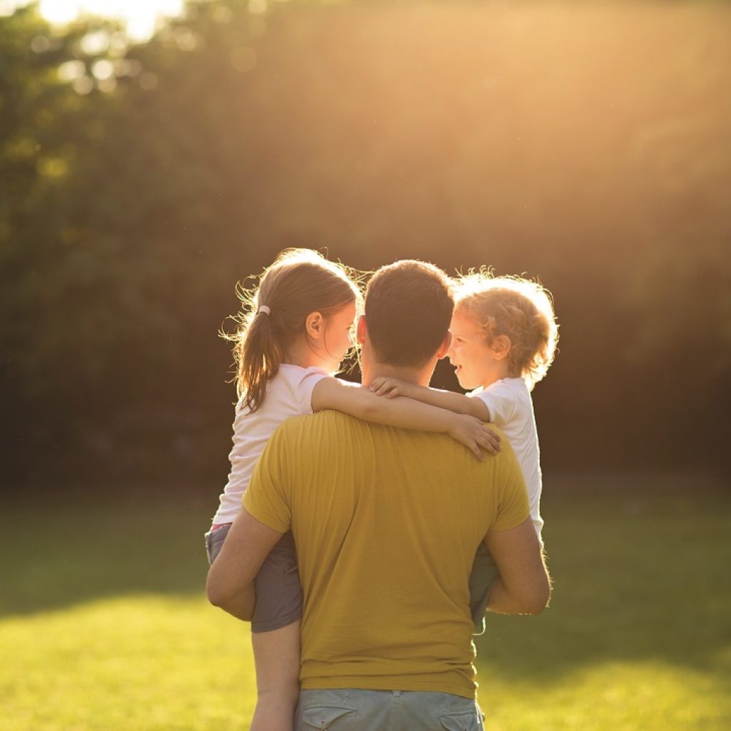 father carrying children